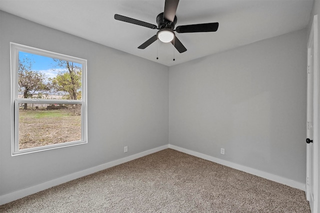 empty room featuring carpet floors and ceiling fan