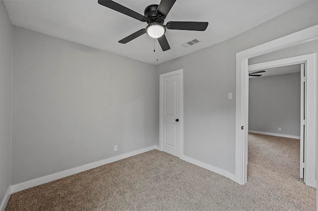 unfurnished bedroom with light colored carpet and ceiling fan