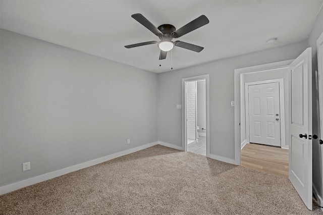 unfurnished bedroom featuring ceiling fan, connected bathroom, and light carpet