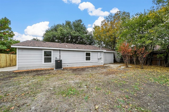 rear view of property featuring central AC unit