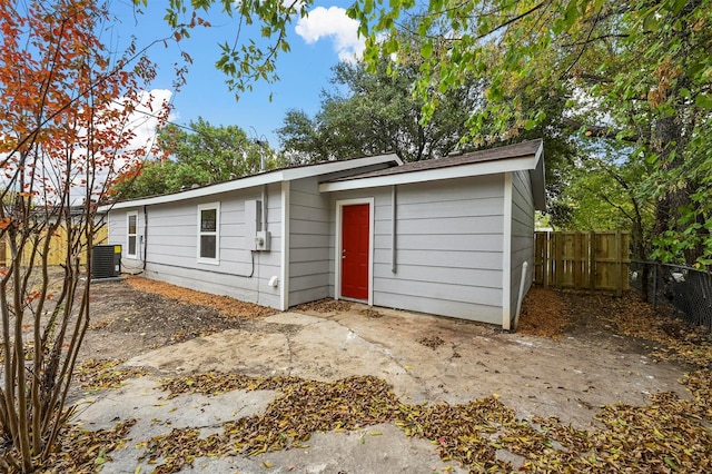 rear view of house featuring central AC