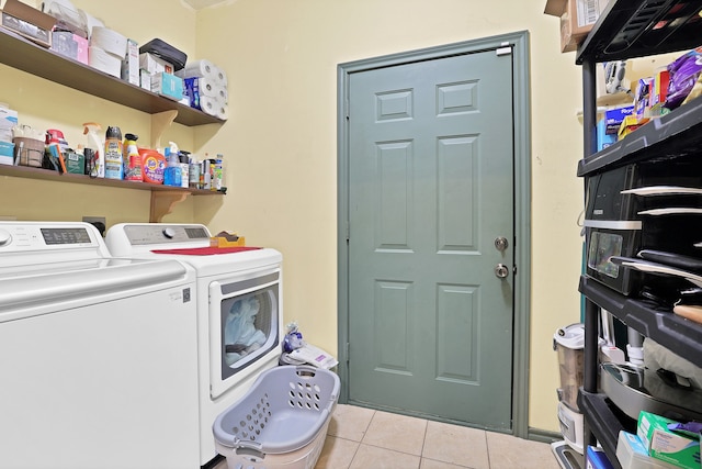 washroom with independent washer and dryer and light tile patterned floors