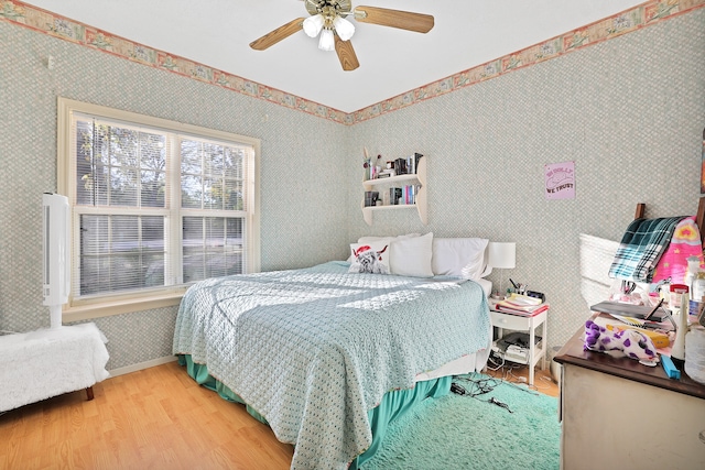 bedroom with hardwood / wood-style flooring and ceiling fan