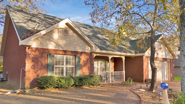 view of front facade with covered porch and a garage