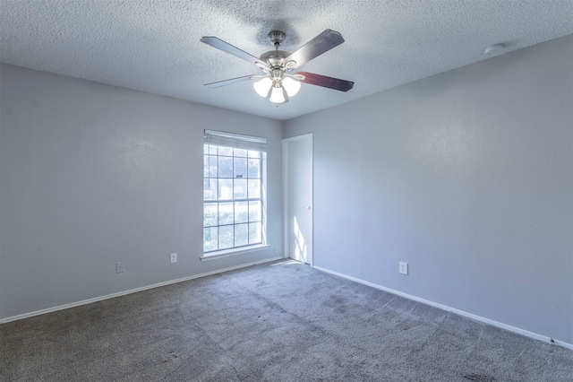 carpeted empty room with ceiling fan and a textured ceiling