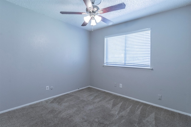 carpeted empty room featuring a textured ceiling and ceiling fan