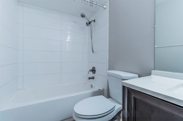 full bathroom with tiled shower / bath, vanity, and toilet