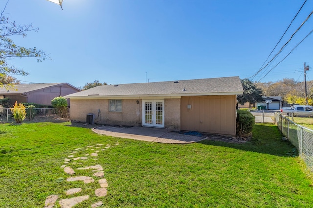 rear view of house featuring a lawn, a patio area, french doors, and central AC