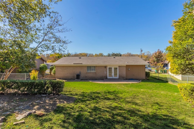 back of house with a lawn, a patio area, french doors, and central air condition unit