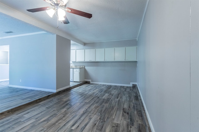 spare room with hardwood / wood-style floors, ceiling fan, crown molding, and a textured ceiling