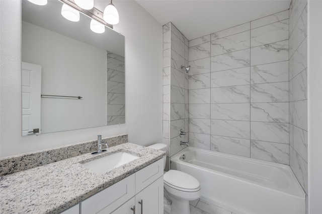 full bathroom with vanity, toilet, and tiled shower / bath