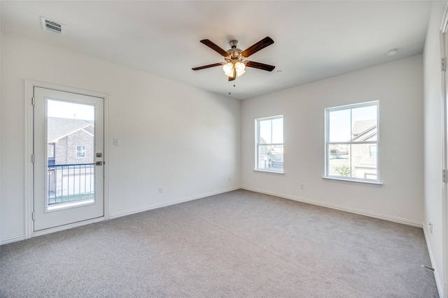 empty room with light colored carpet and ceiling fan