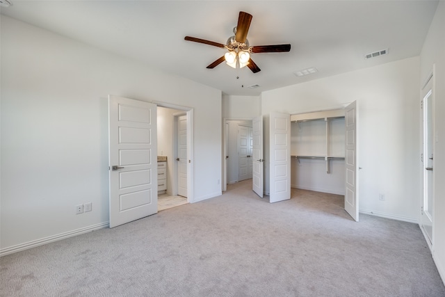 unfurnished bedroom with light carpet, a closet, and ceiling fan