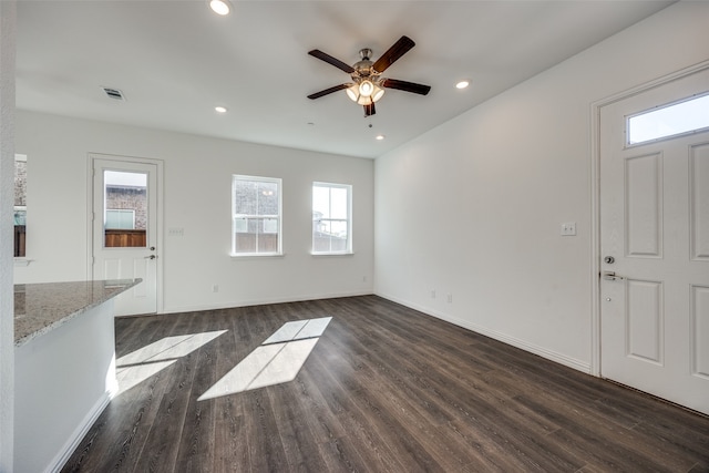 unfurnished living room featuring dark hardwood / wood-style floors and ceiling fan