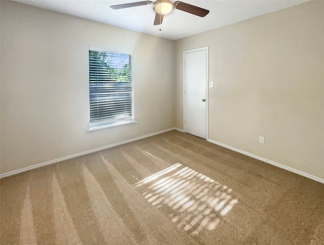 carpeted empty room featuring ceiling fan