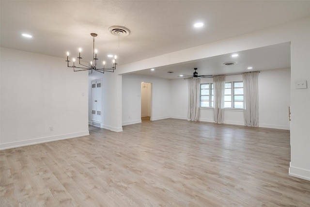 unfurnished room featuring light hardwood / wood-style floors and ceiling fan with notable chandelier