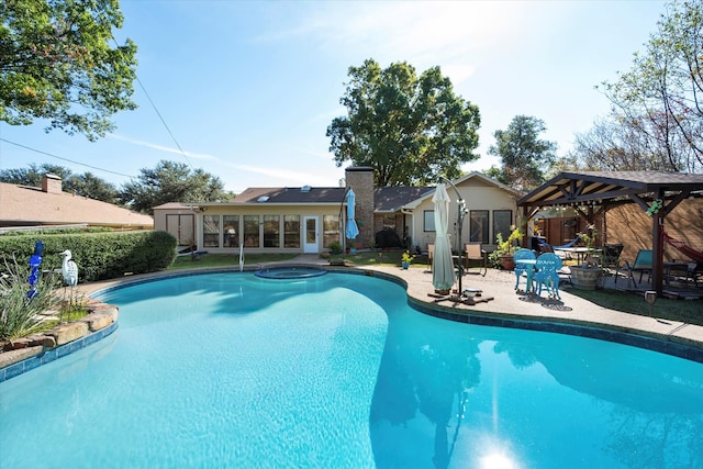 view of swimming pool featuring a gazebo and an in ground hot tub