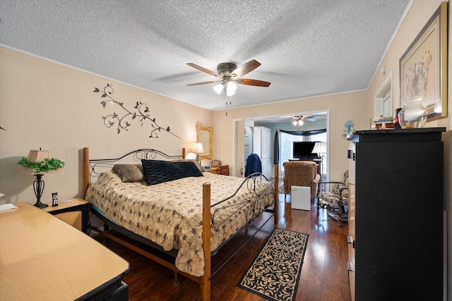 bedroom featuring a textured ceiling, ceiling fan, and dark hardwood / wood-style floors