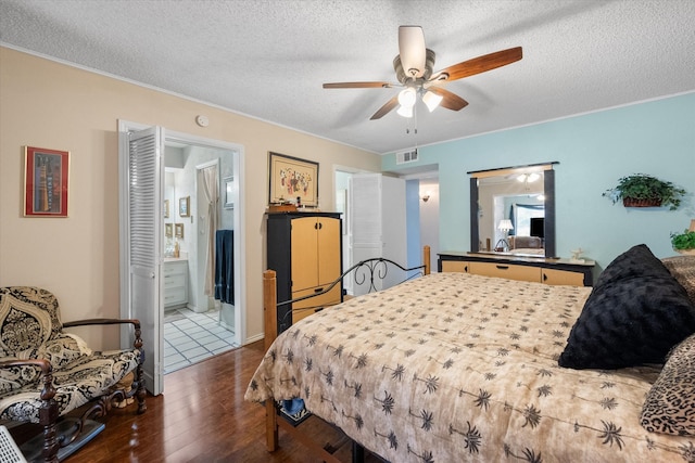 bedroom with ceiling fan, ensuite bathroom, a textured ceiling, and hardwood / wood-style flooring