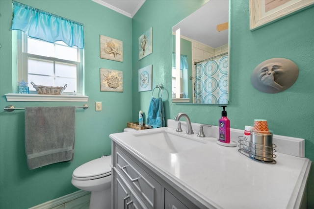 bathroom with a shower with curtain, ornamental molding, vanity, and toilet