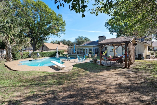 view of swimming pool featuring a diving board and a patio