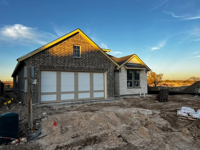 back house at dusk with a garage