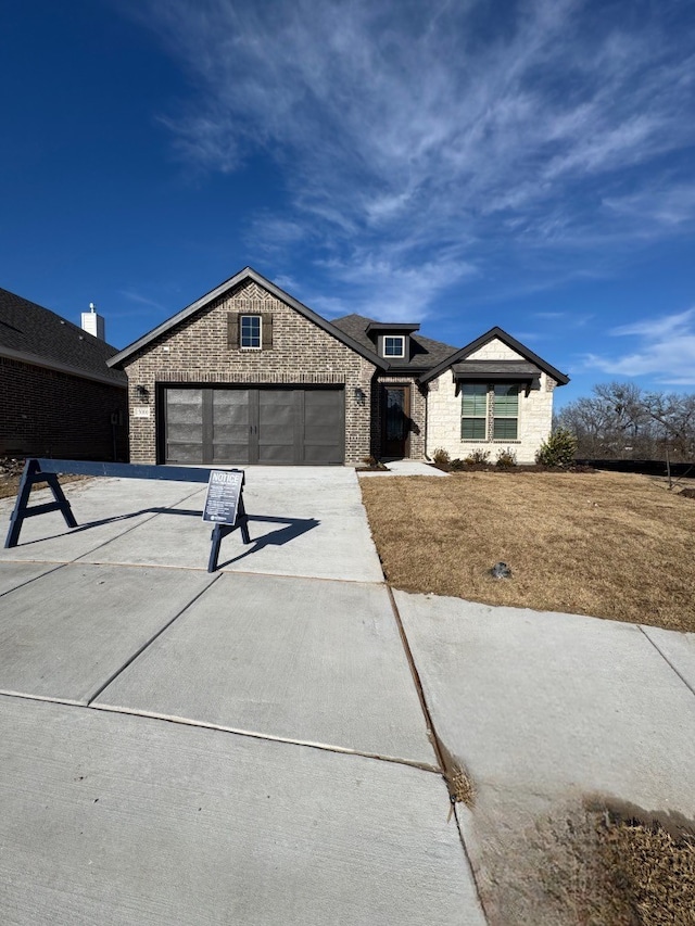 view of front of property with a garage and a front yard