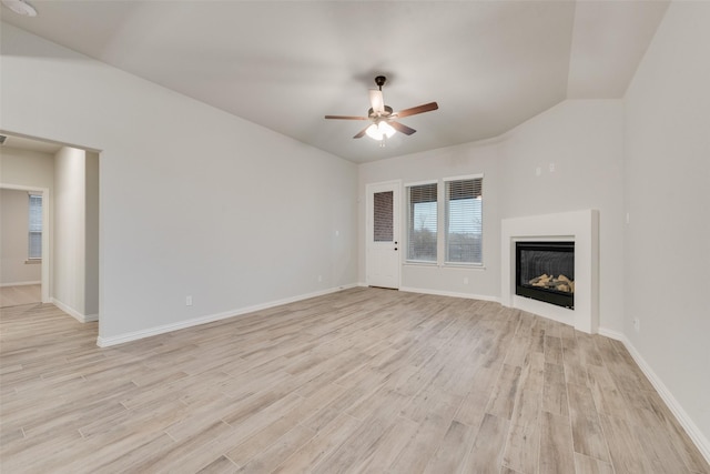 unfurnished living room featuring ceiling fan, vaulted ceiling, and light hardwood / wood-style floors