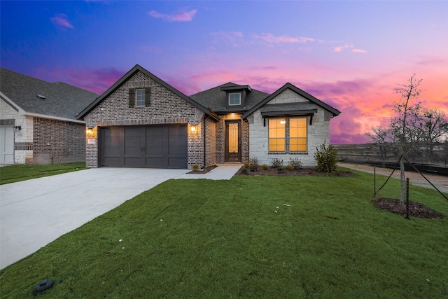 view of front facade with a garage and a yard