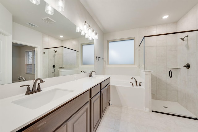 bathroom featuring tile patterned floors, vanity, separate shower and tub, and a wealth of natural light