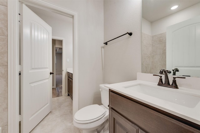 bathroom featuring vanity and toilet