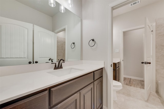 bathroom featuring vanity and toilet