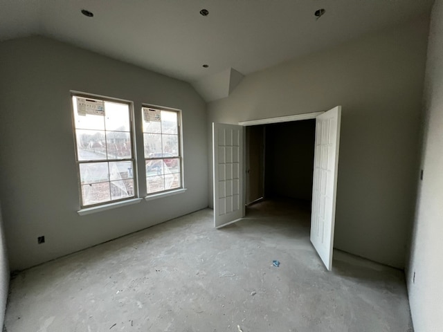 unfurnished bedroom with lofted ceiling