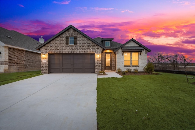 view of front facade with a garage and a yard