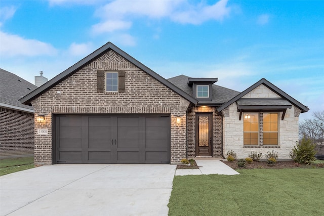 view of front of house with a garage and a front lawn