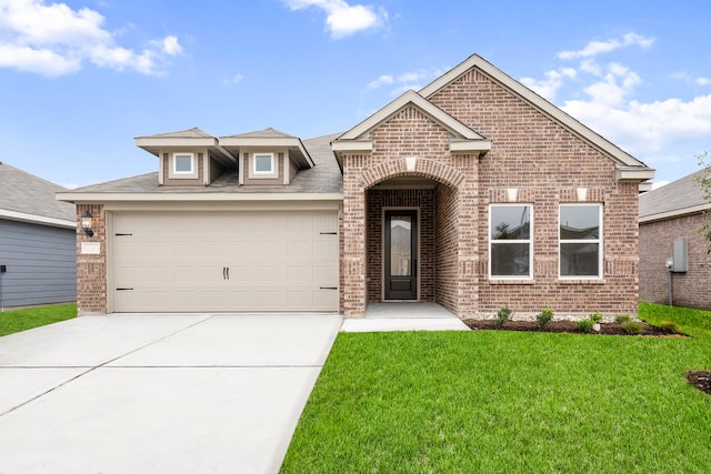 view of front of property with a garage and a front lawn