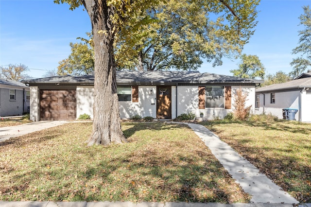 ranch-style house with a garage and a front yard