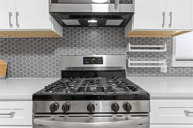 kitchen with white cabinetry, backsplash, exhaust hood, and appliances with stainless steel finishes