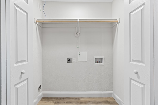 washroom with hookup for an electric dryer, hookup for a washing machine, and light wood-type flooring