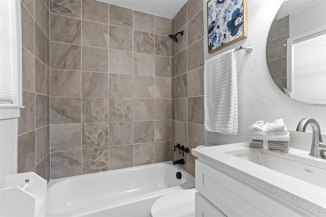 full bathroom with vanity, toilet, and tiled shower / bath