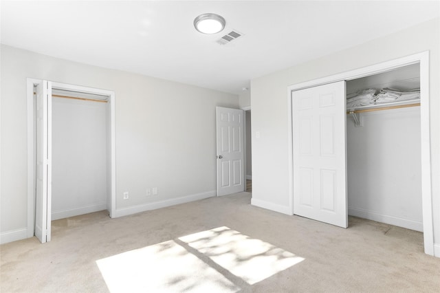 unfurnished bedroom featuring light colored carpet