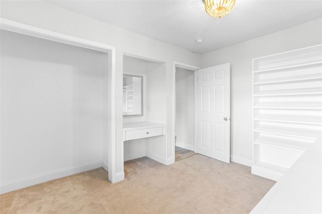 unfurnished bedroom with light carpet and a textured ceiling