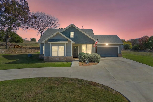 view of front of home with a yard and a garage