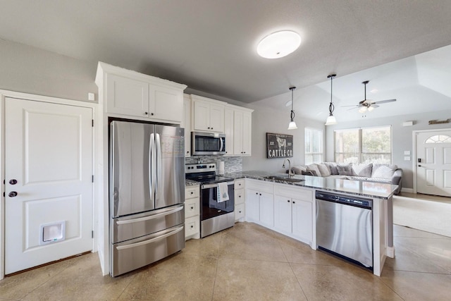 kitchen featuring kitchen peninsula, white cabinets, and stainless steel appliances