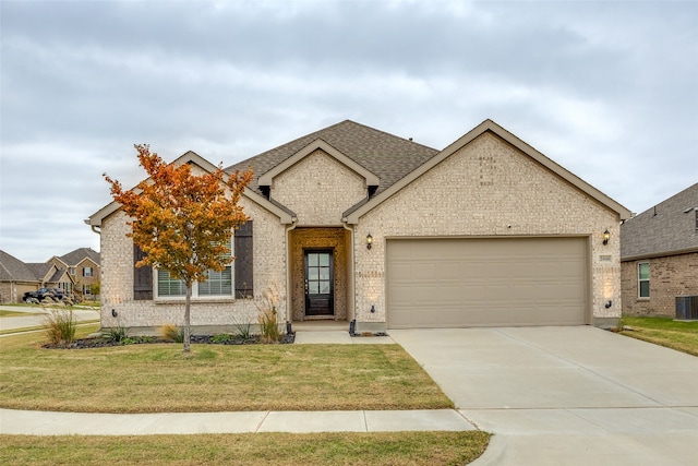 view of front of home with a front yard, a garage, and cooling unit