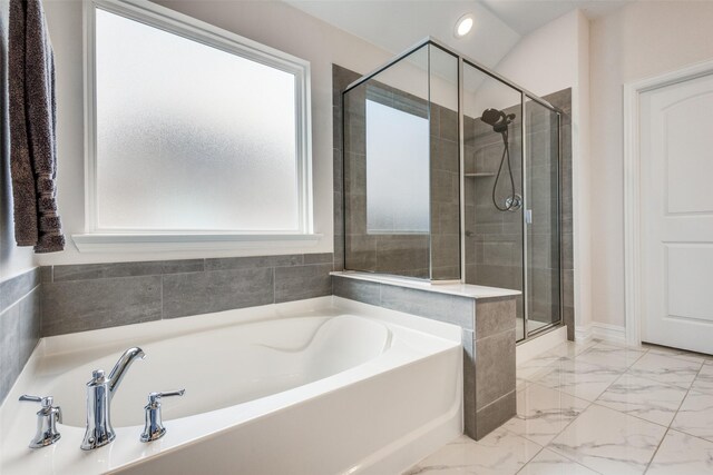 bathroom featuring plus walk in shower and a wealth of natural light