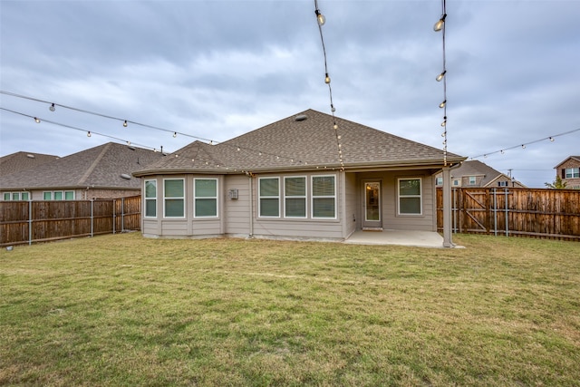 rear view of house featuring a patio area and a yard