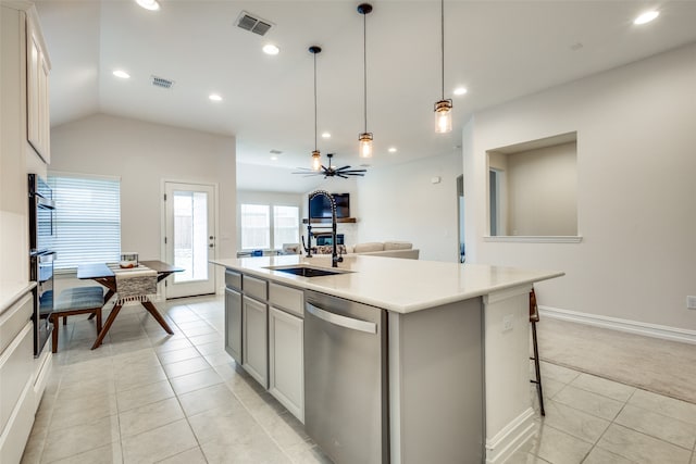 kitchen featuring appliances with stainless steel finishes, sink, pendant lighting, and an island with sink