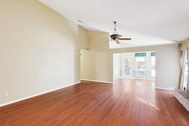 unfurnished living room with ceiling fan, wood-type flooring, high vaulted ceiling, and a textured ceiling