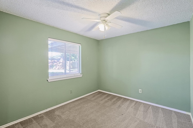 unfurnished room with ceiling fan, carpet flooring, and a textured ceiling